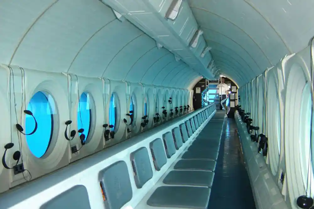 The interior looking down the hull, viewports on both sides and bench seating