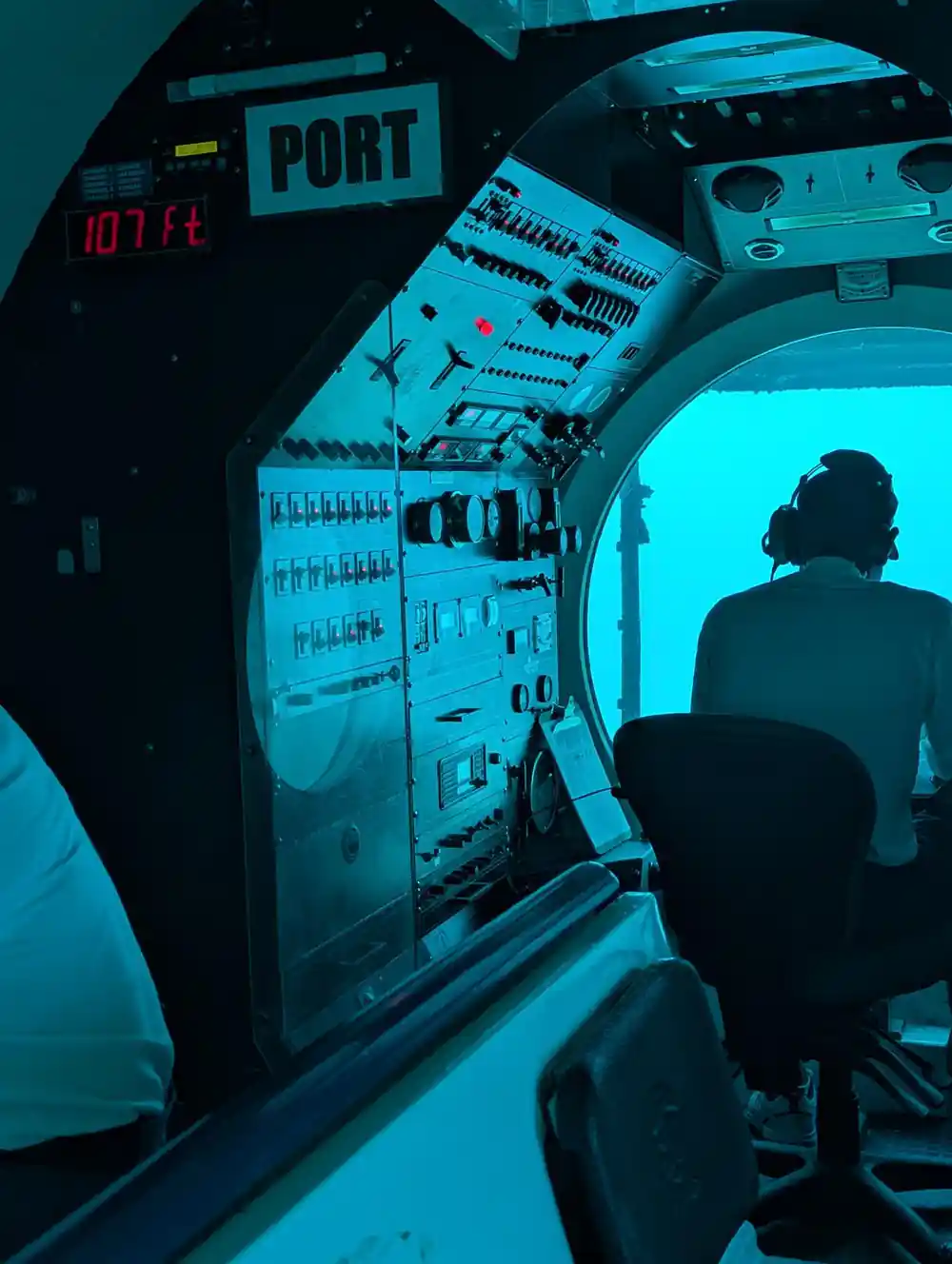 The pilot silhouetted against the forward dome with the control panel lit