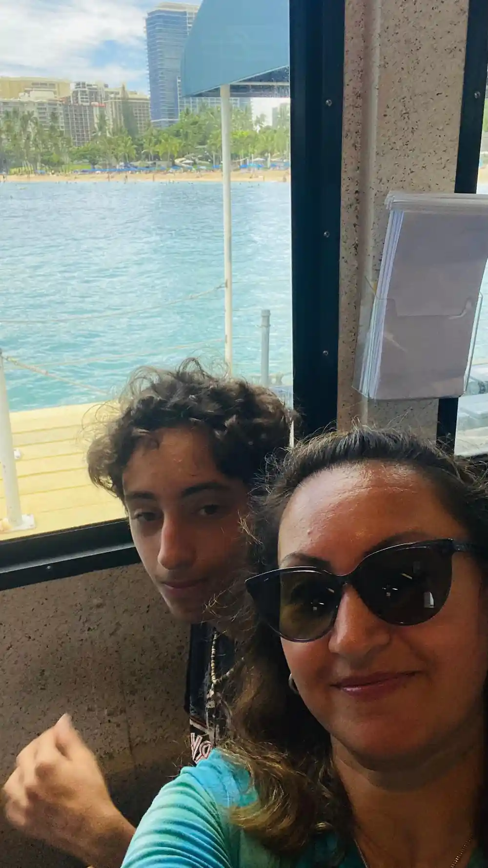 Two passengers taking a photograph beside a viewport